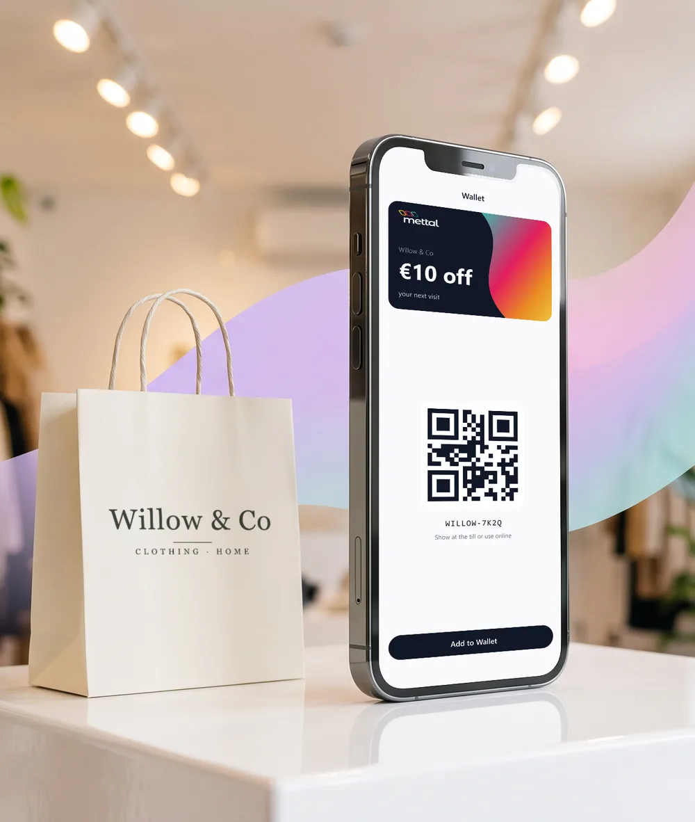 A phone showing a €10 off voucher from Willow & Co with a QR code, next to a Willow & Co shopping bag.